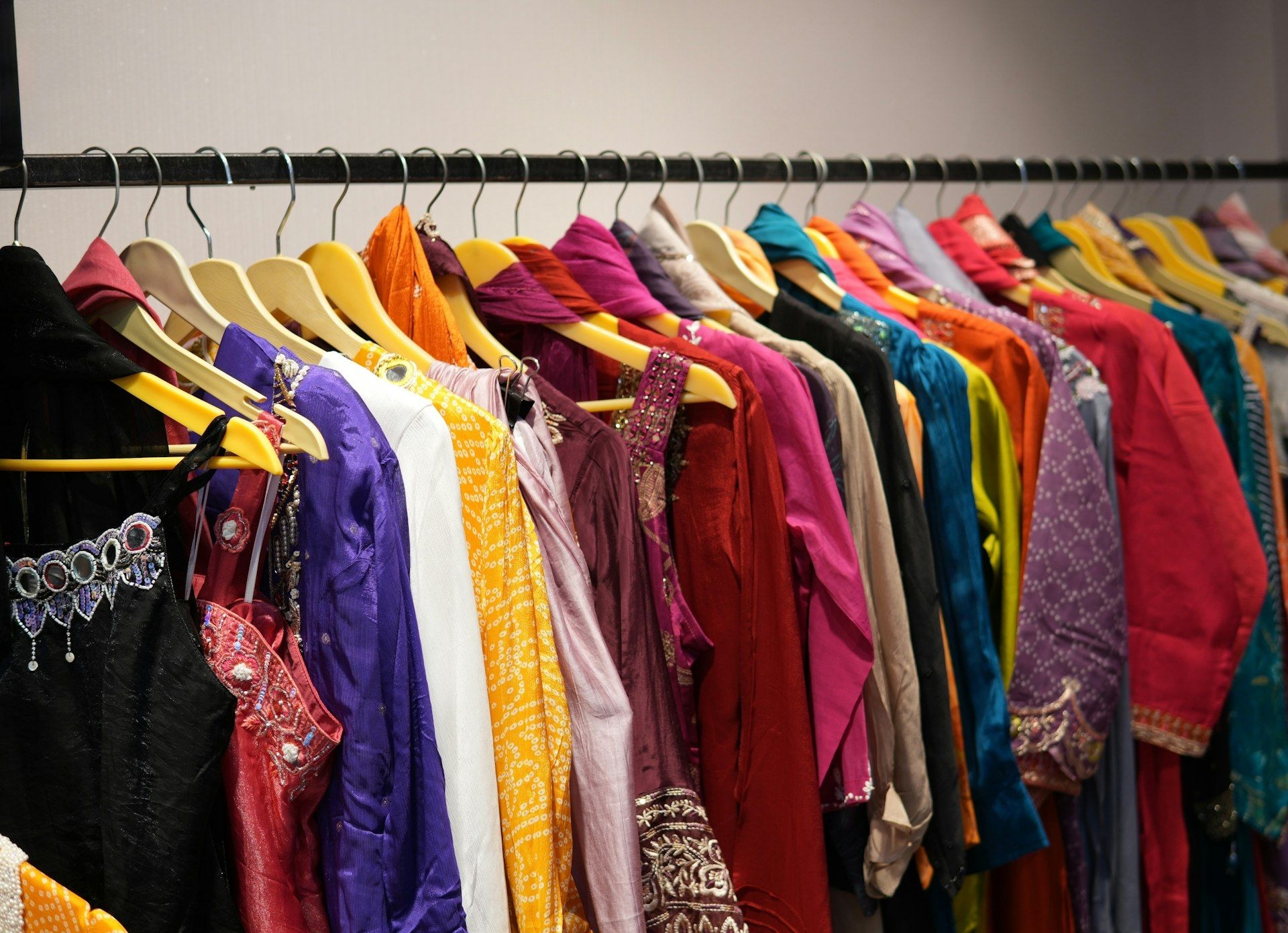 Womenswear in a full colour range hanging on a showroom rail