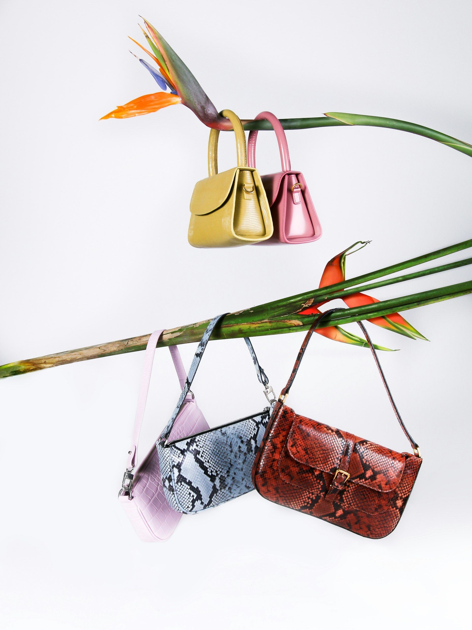 A leather sling bag hanging on a display hook