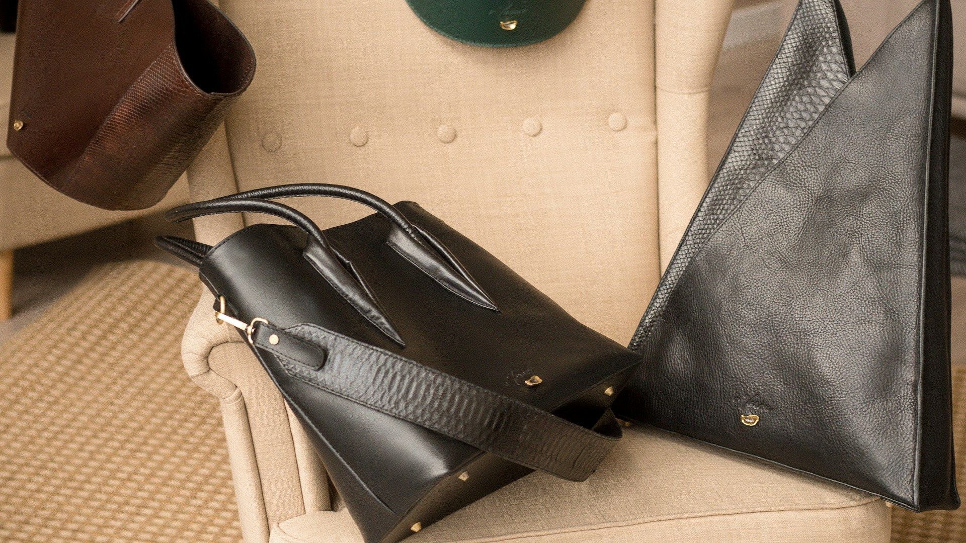 Leather bags laid out on a showroom chair