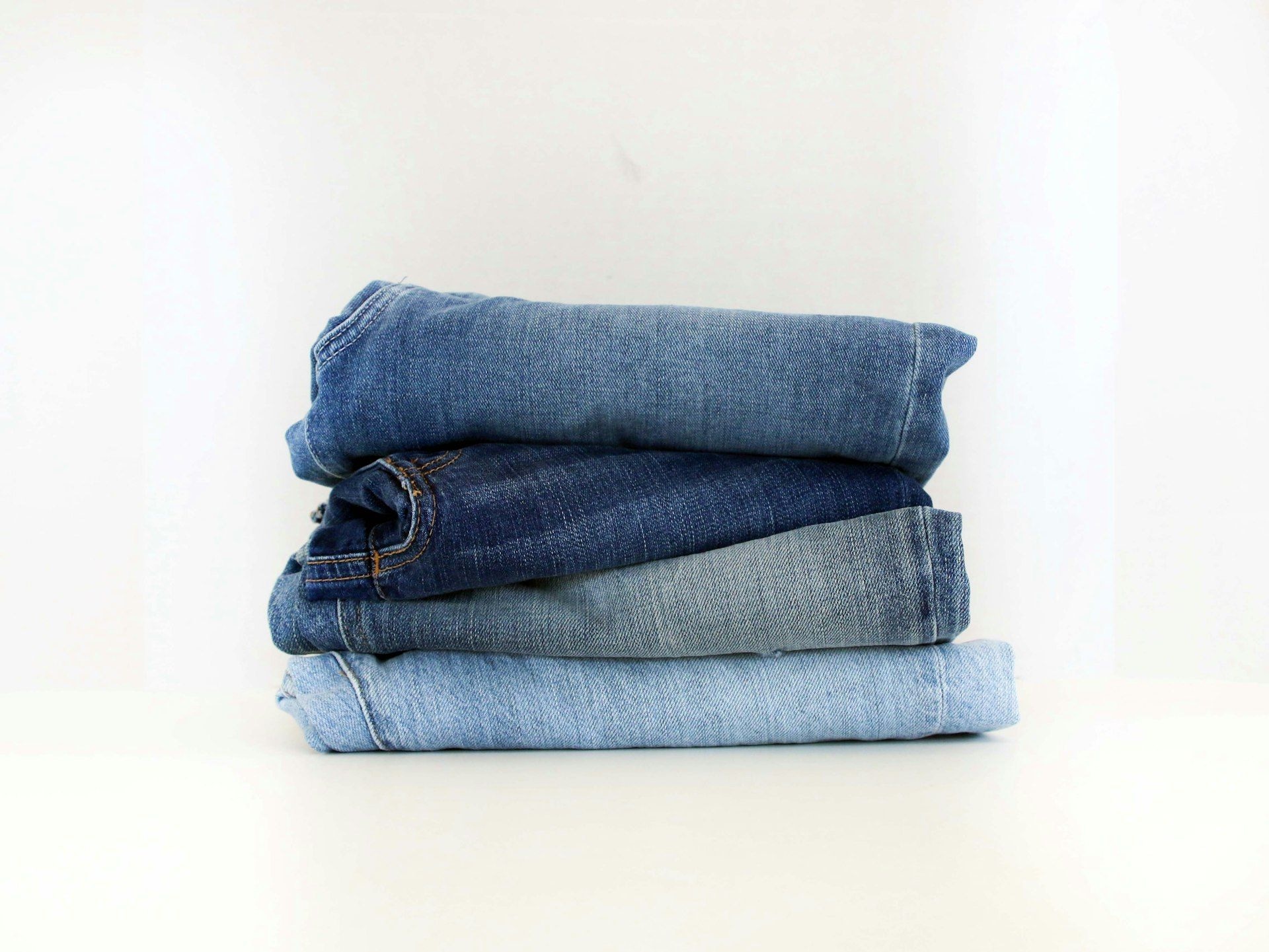 Folded denim stacked on a display surface