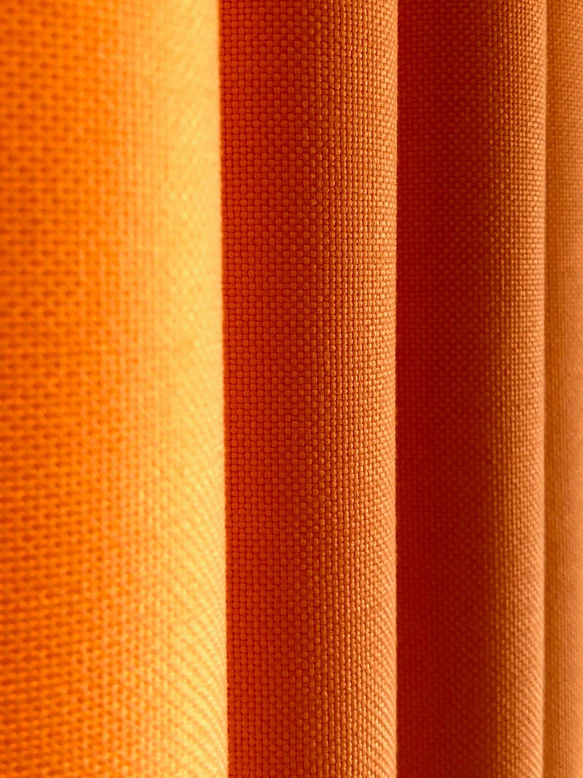 Bolts of plain woven fabric standing on end