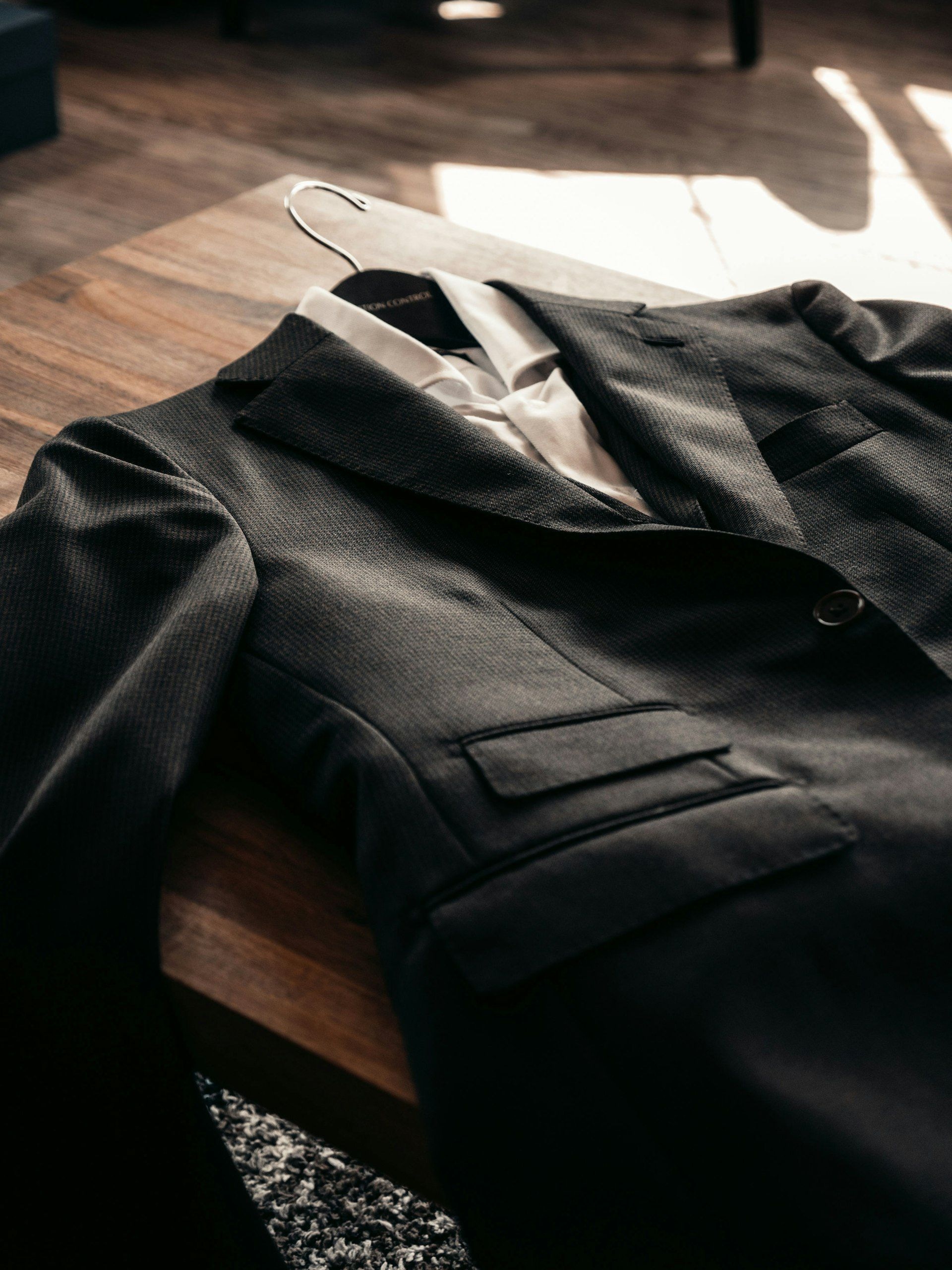 A tailored jacket laid out on a work table