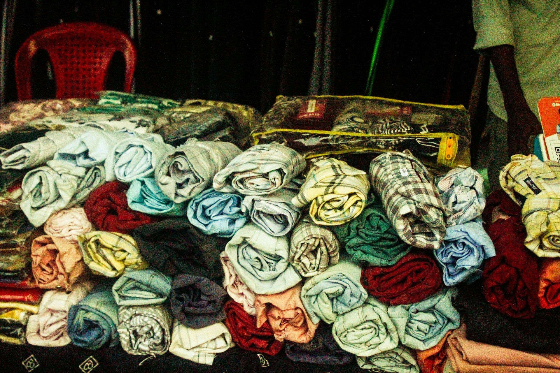 Rolled garments stacked on a wholesale stall