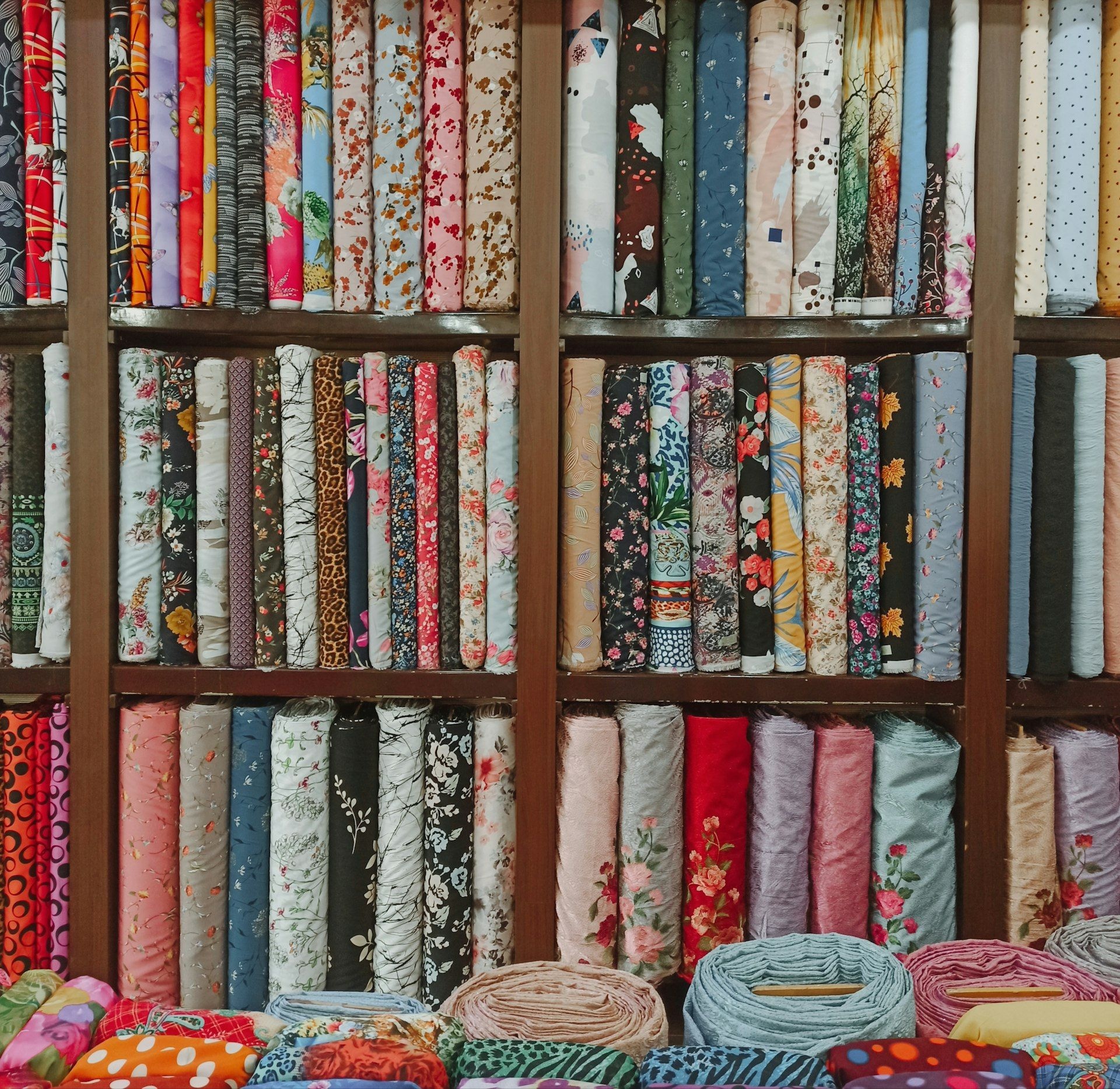 Shelved bolts of patterned cloth in a textile showroom
