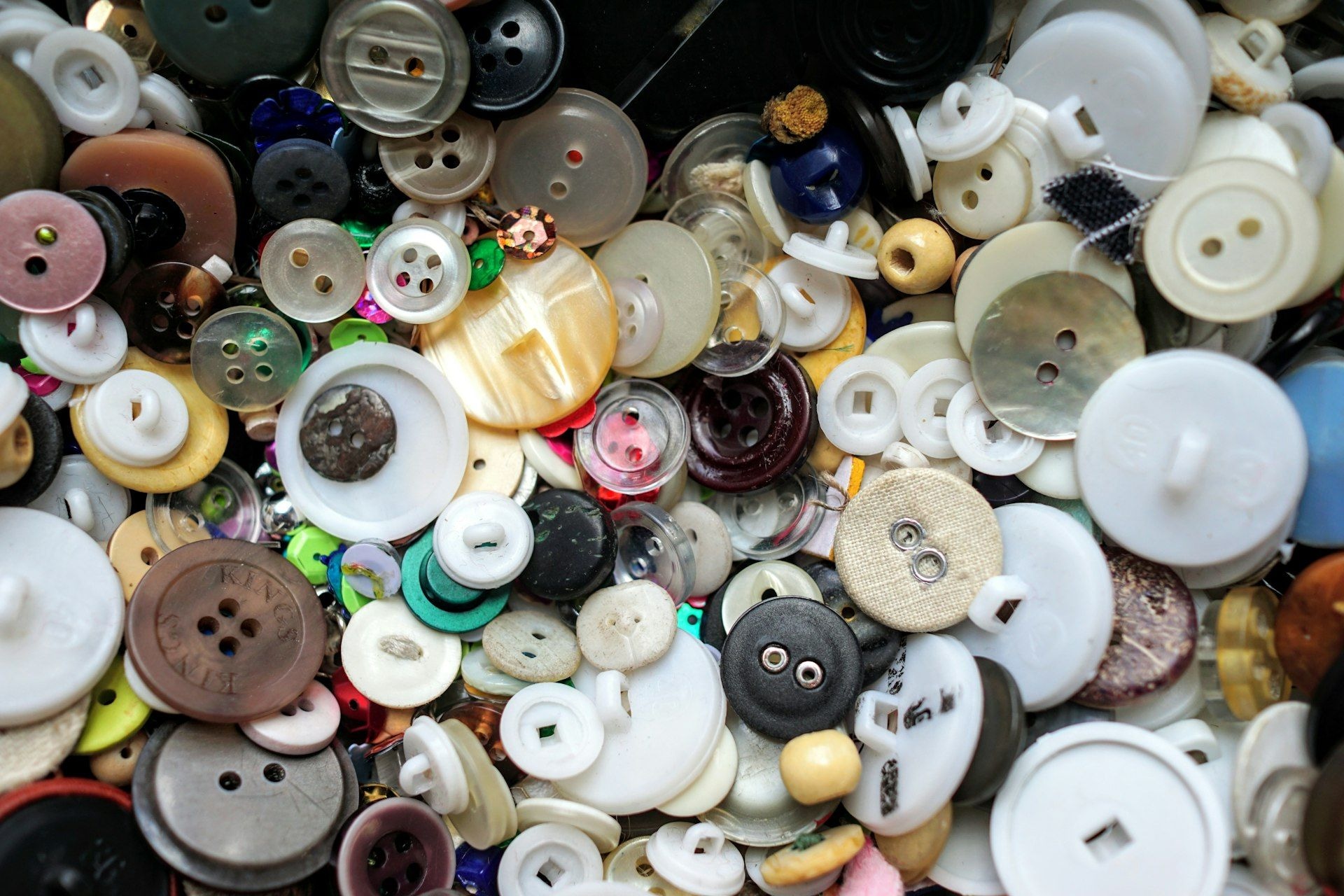 Assorted buttons sorted by colour and size