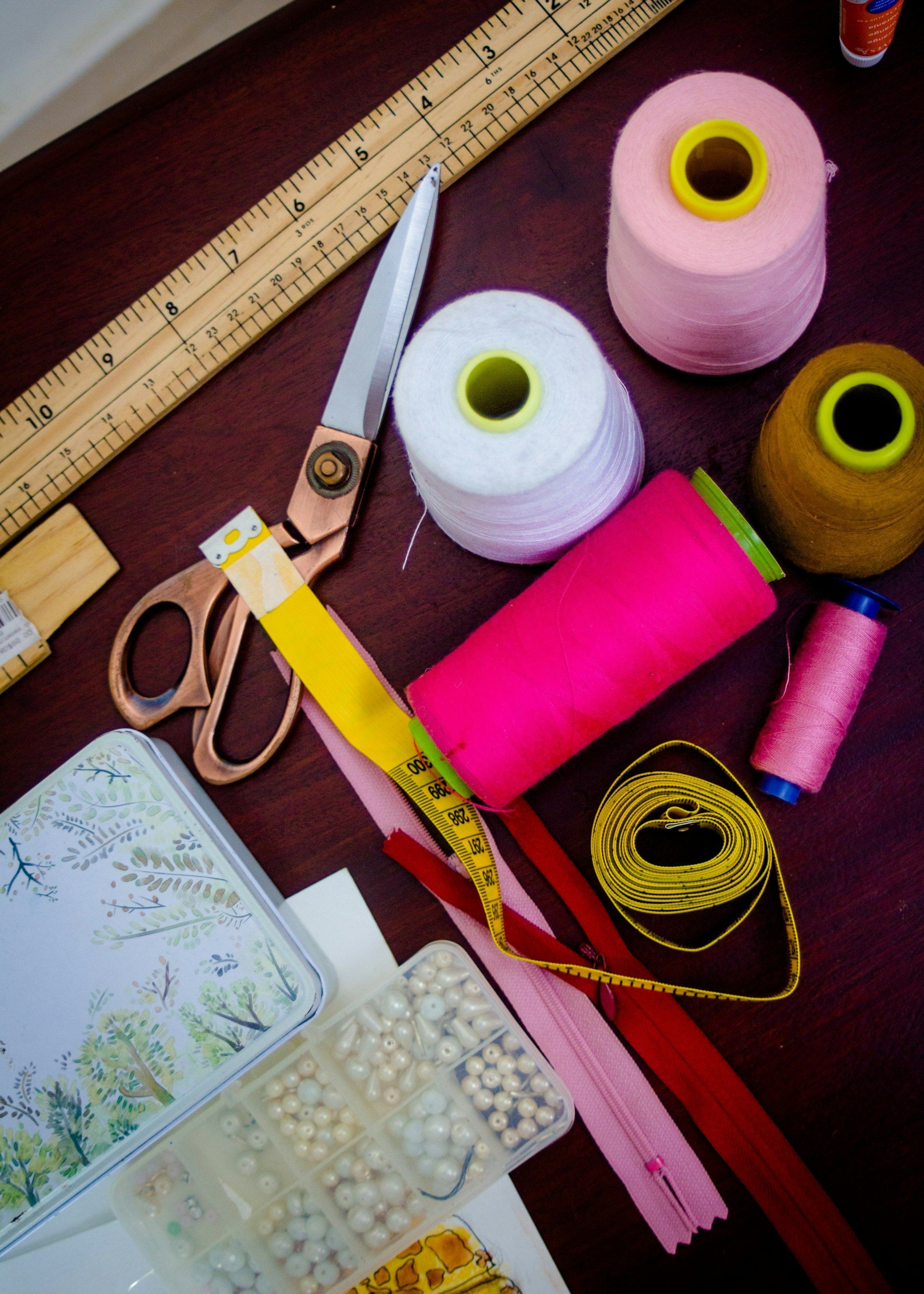 Threads, spools and shears on a haberdashery bench