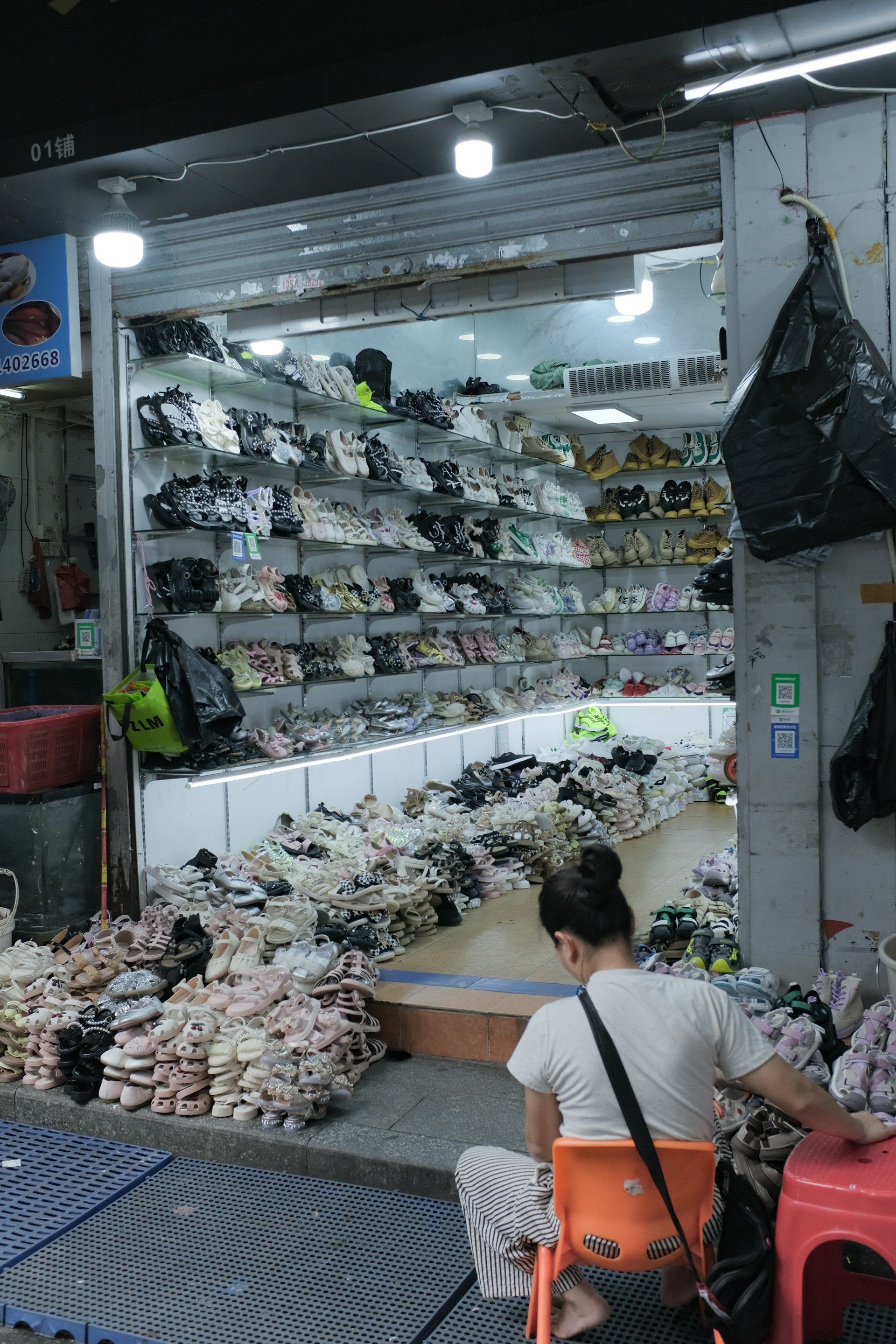 A shoe wholesale unit stocked with sandals and sneakers