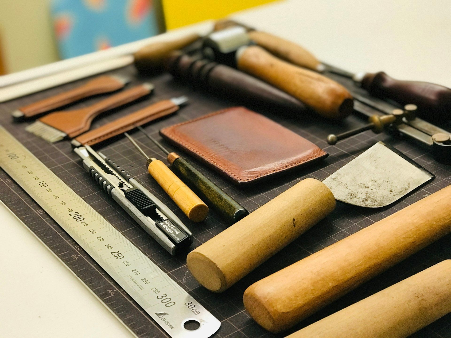Leather-working tools and cut components on a bench
