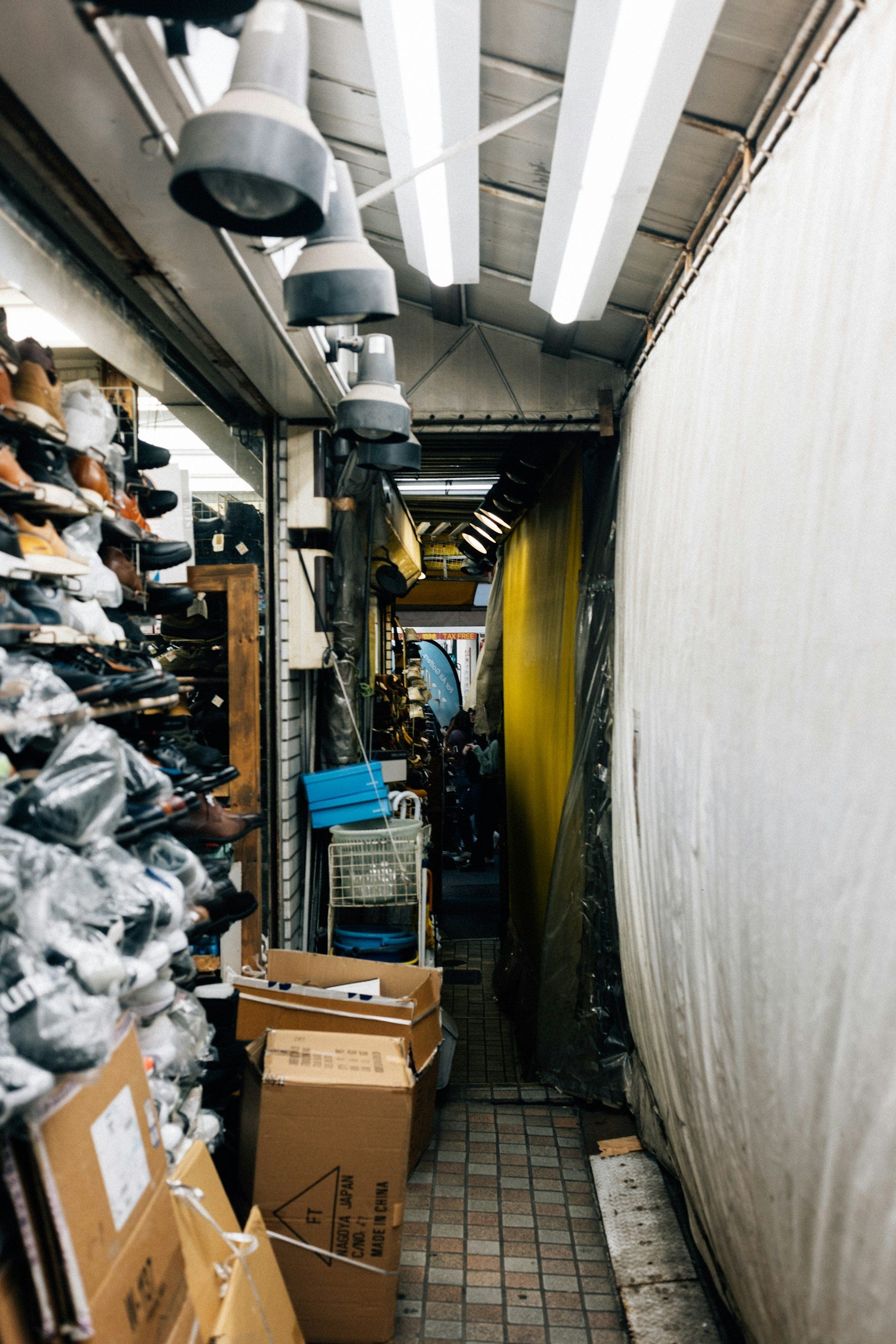 A narrow aisle of a shoe wholesale unit