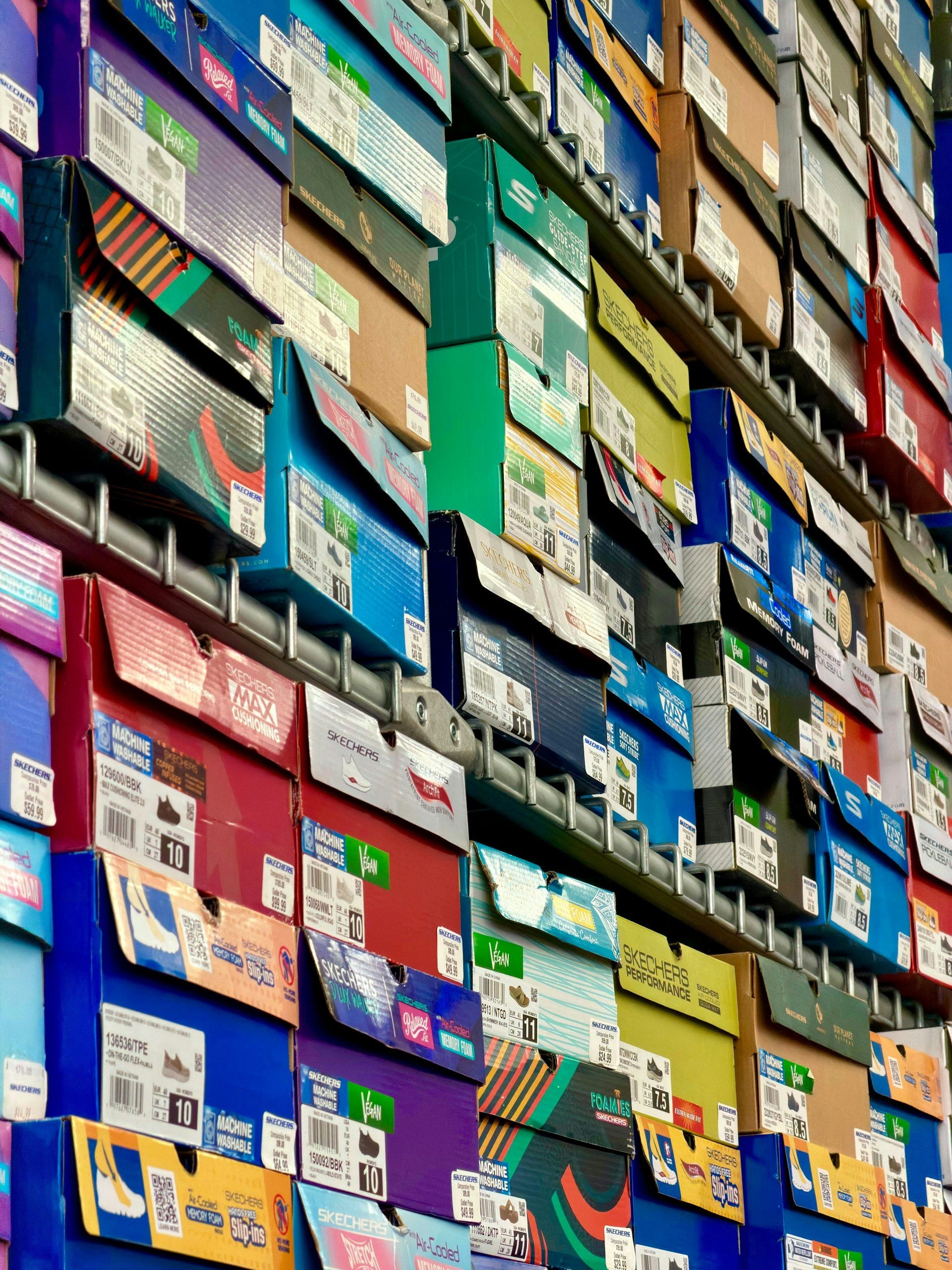 Shoe boxes stacked high on warehouse shelving