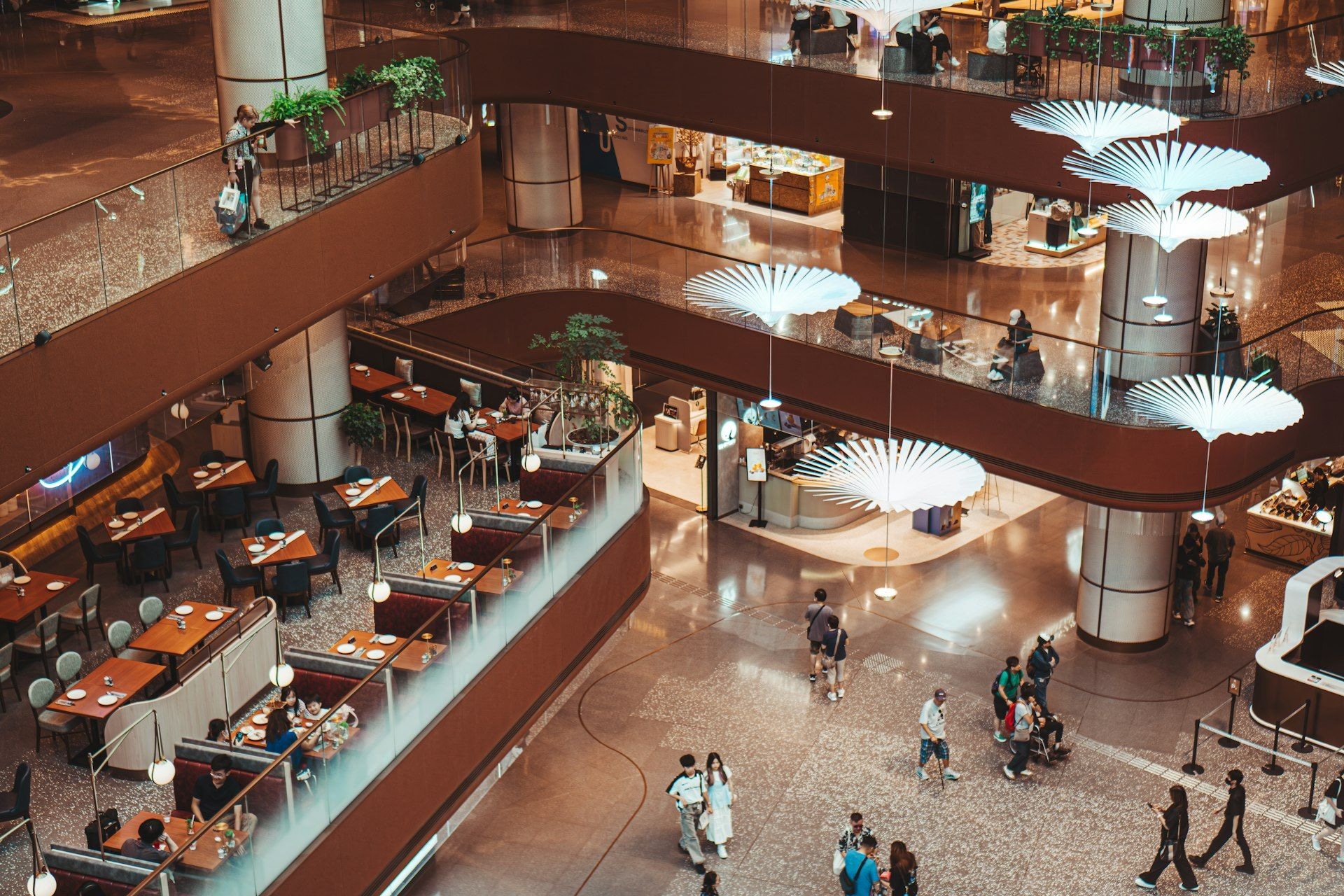 Shoppers on the upper levels of a large retail complex