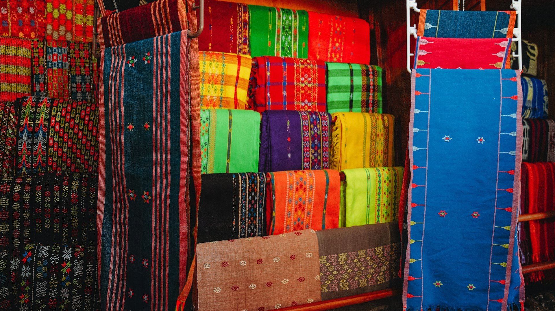 Woven textiles displayed at a market stall