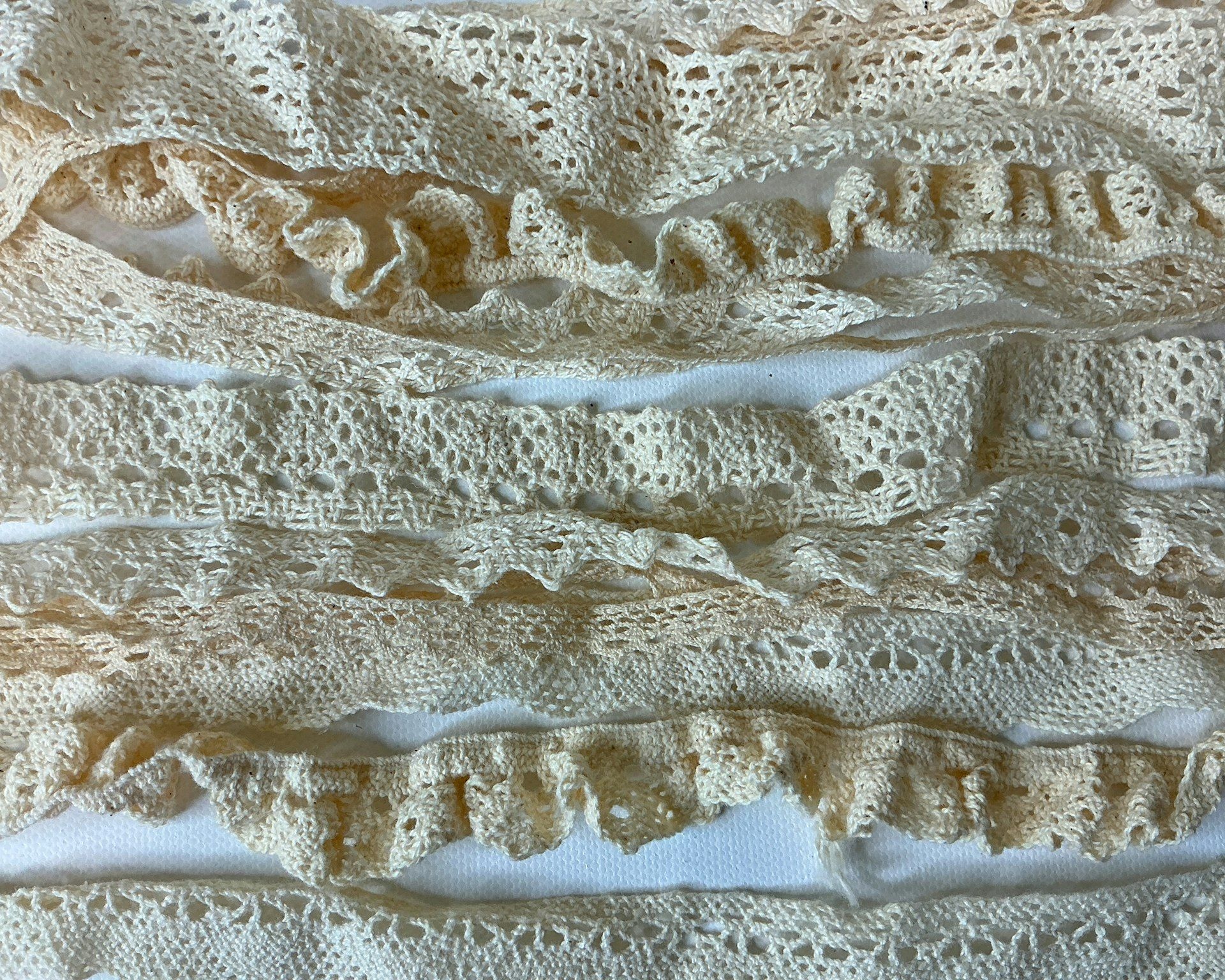 Lace trim in cream, stacked in lengths
