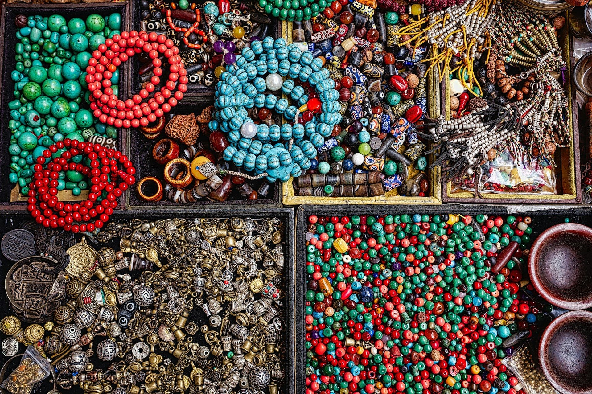 Beads and stones sorted into trays by colour