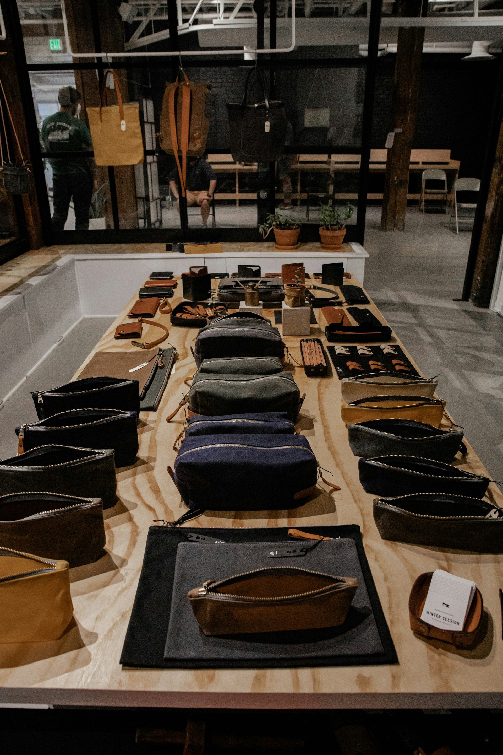 Leather handbags displayed on a wooden table