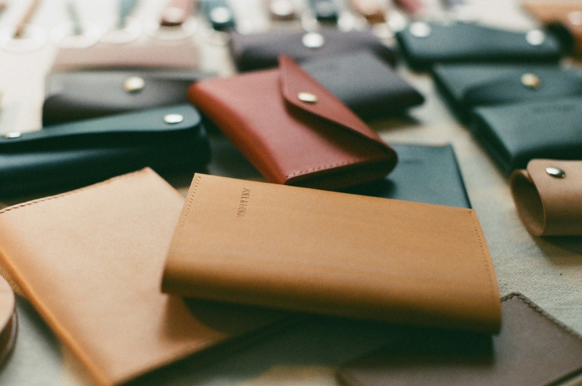 Small leather goods laid out across a workbench