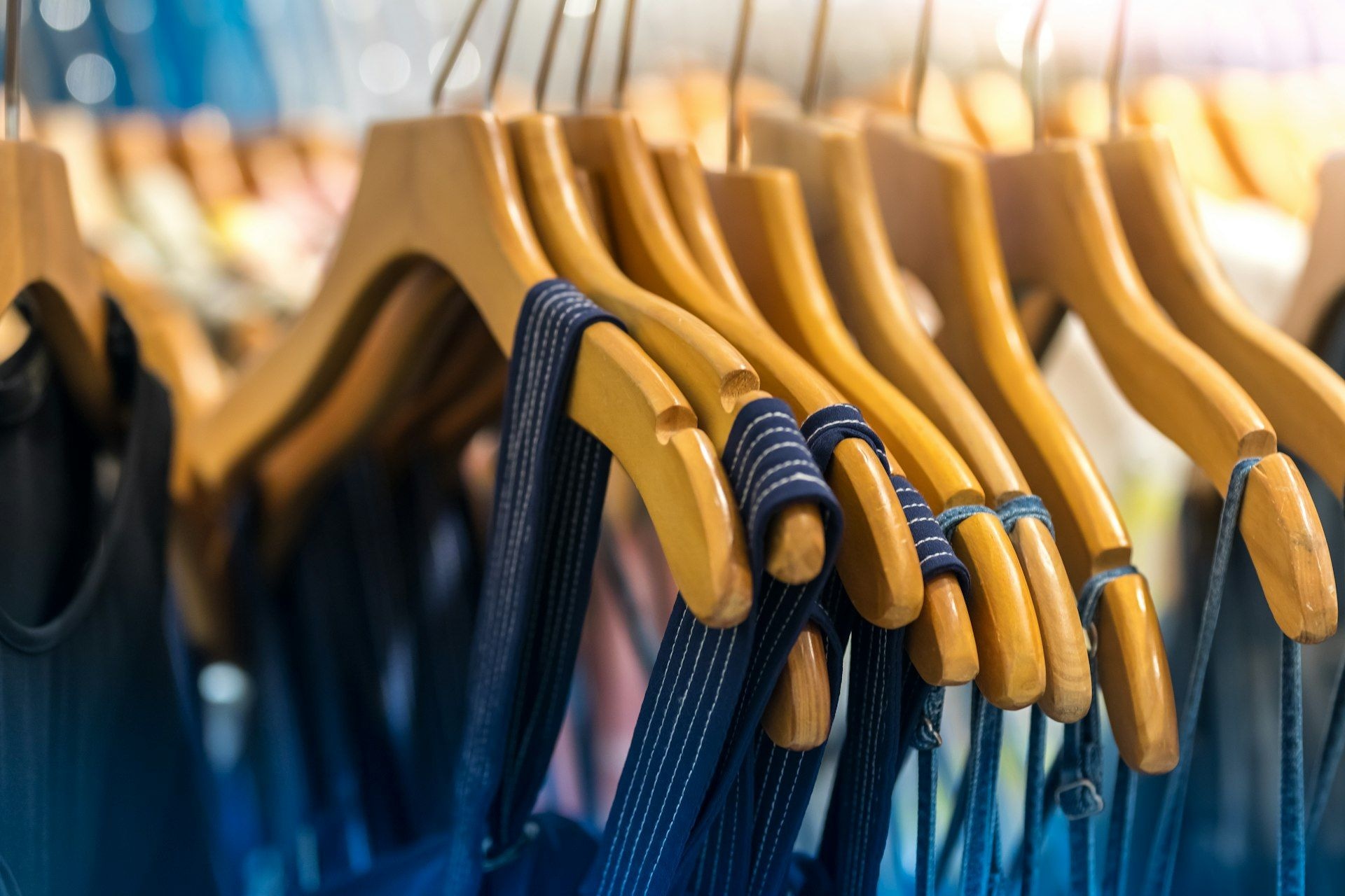 Rows of garments on hangers seen from the aisle