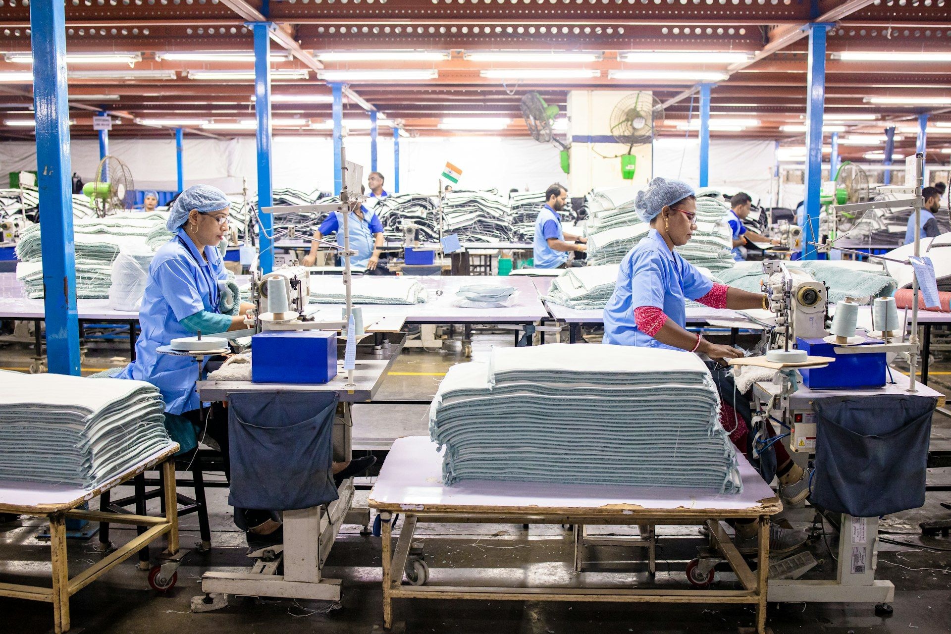 Machinists sewing garments on a production line