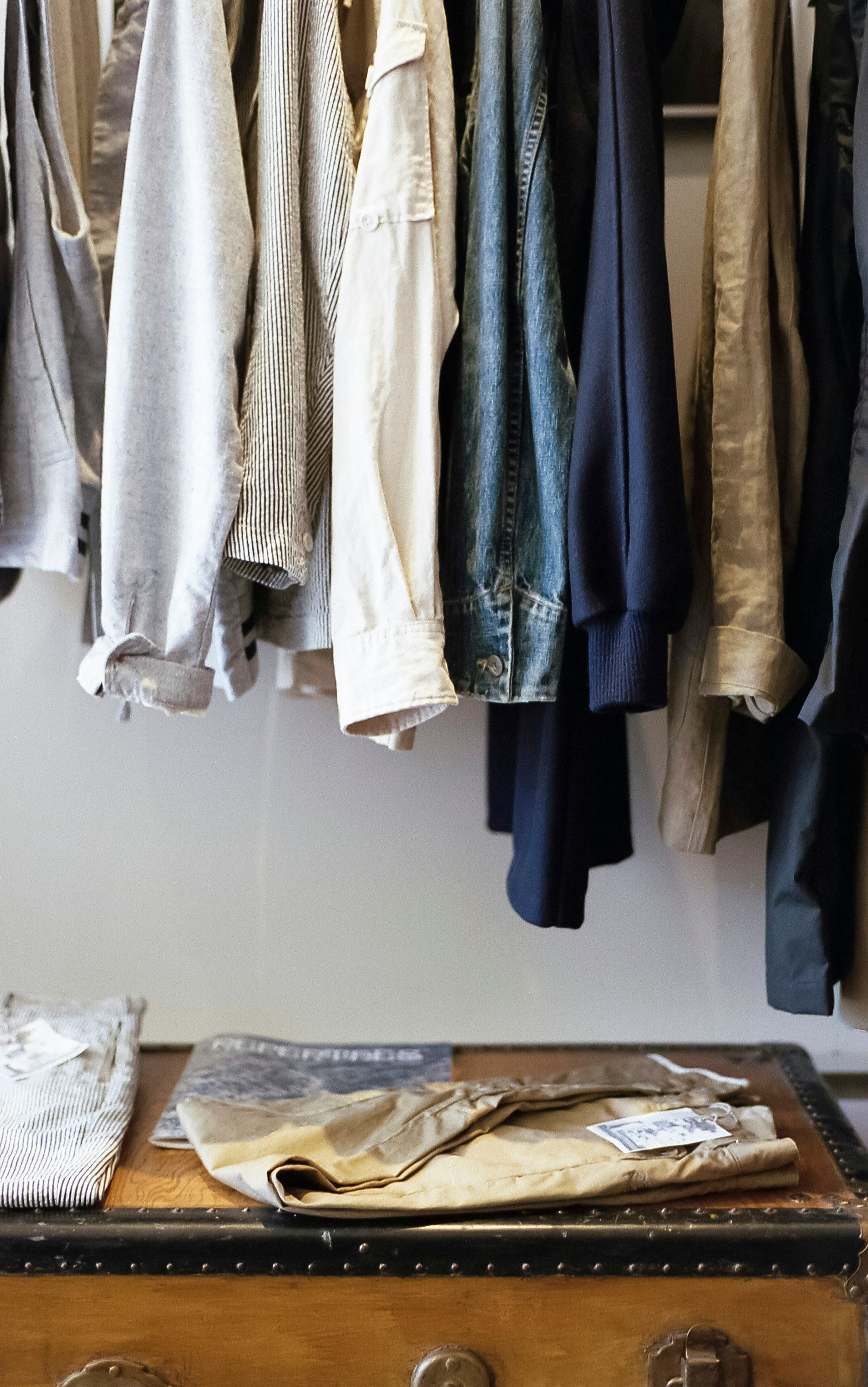 A dense rail of hanging clothes in a trade showroom