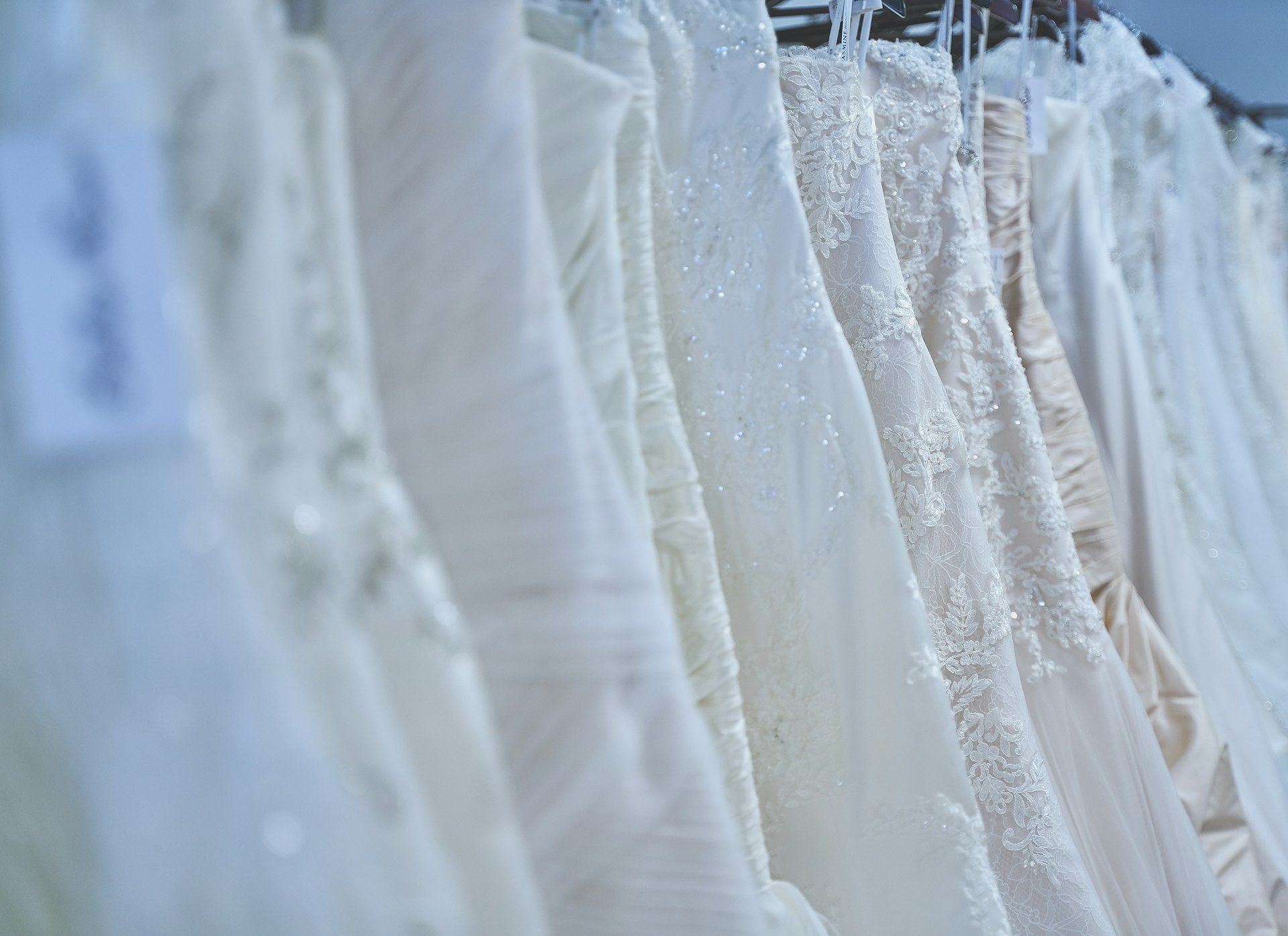 White bridal gowns hanging side by side