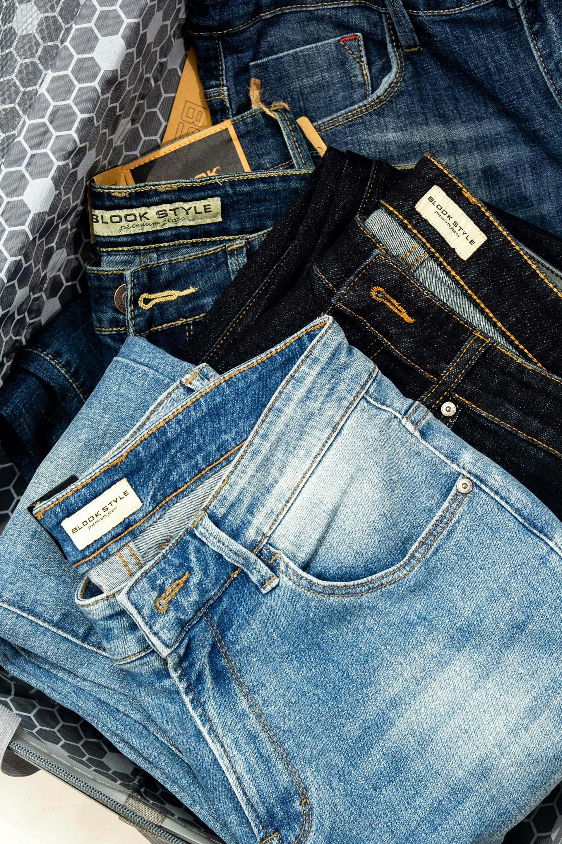 Pairs of jeans laid out to compare fit and wash