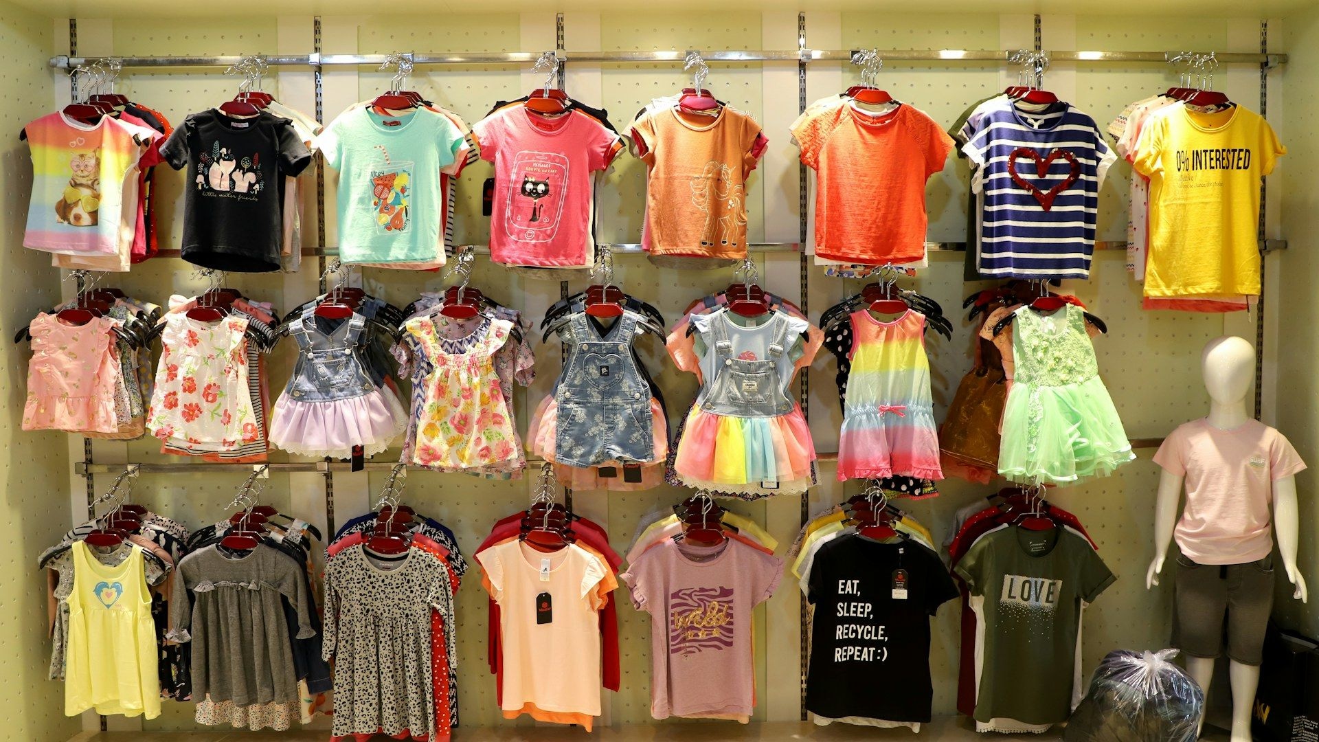 Children's clothing displayed on racks in a wholesale showroom